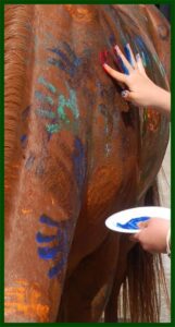 Horse with finger painting and hand